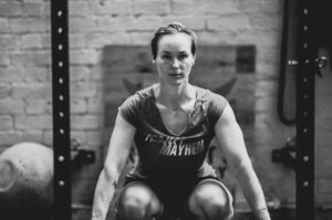 woman personal trainer strong with bar